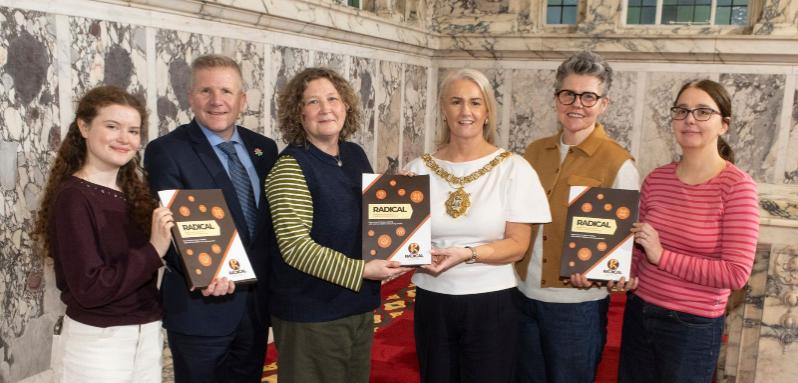 Group of people standing in a row holding reports